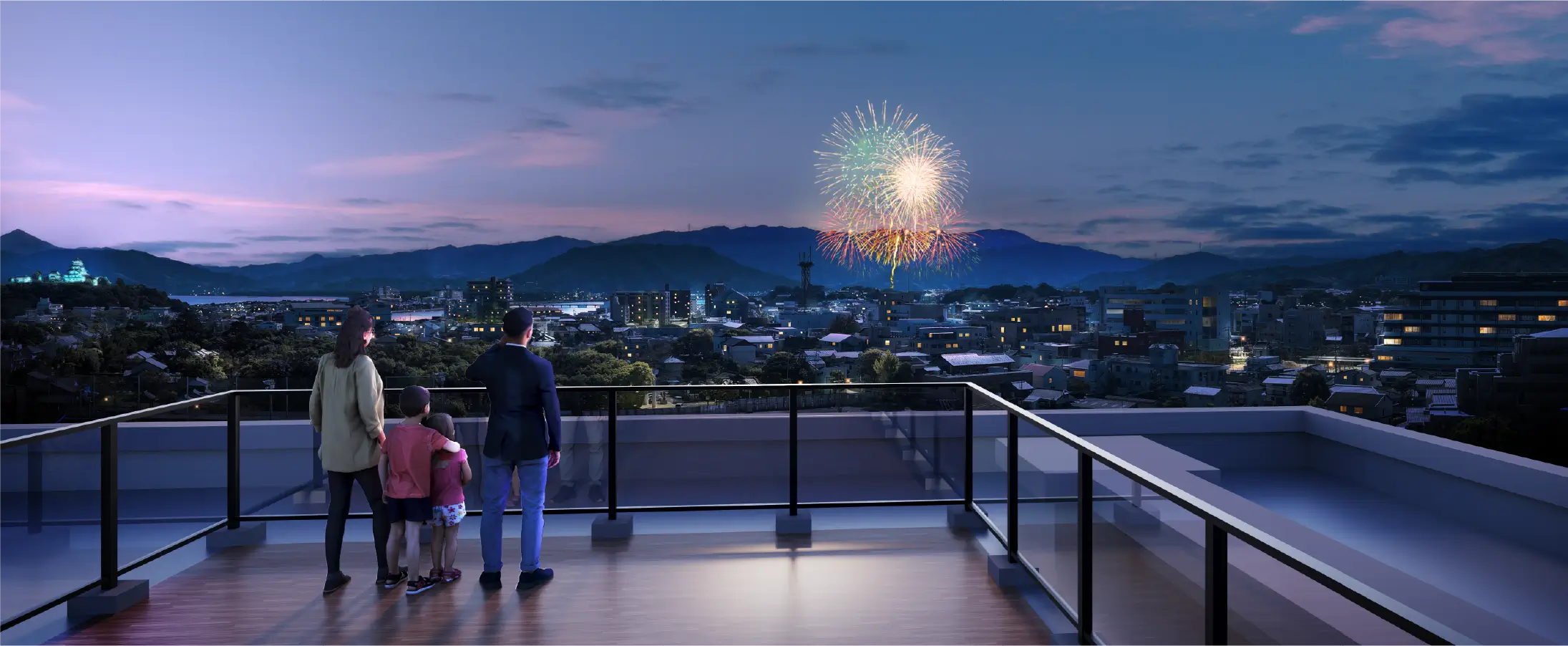 屋上のスカイデッキから花火を見る家族